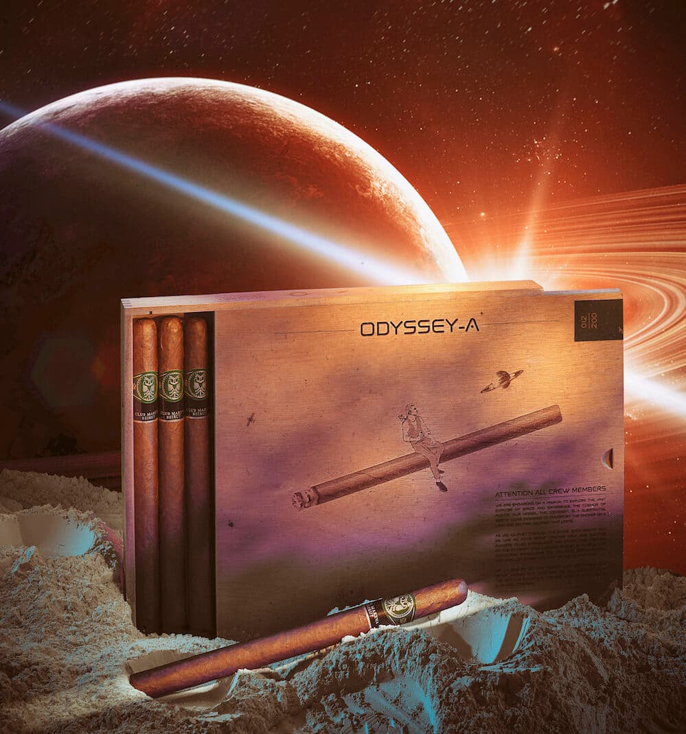 Odyssey box art featuring a smoker riding a cigar through space, with three Gran Corona cigars